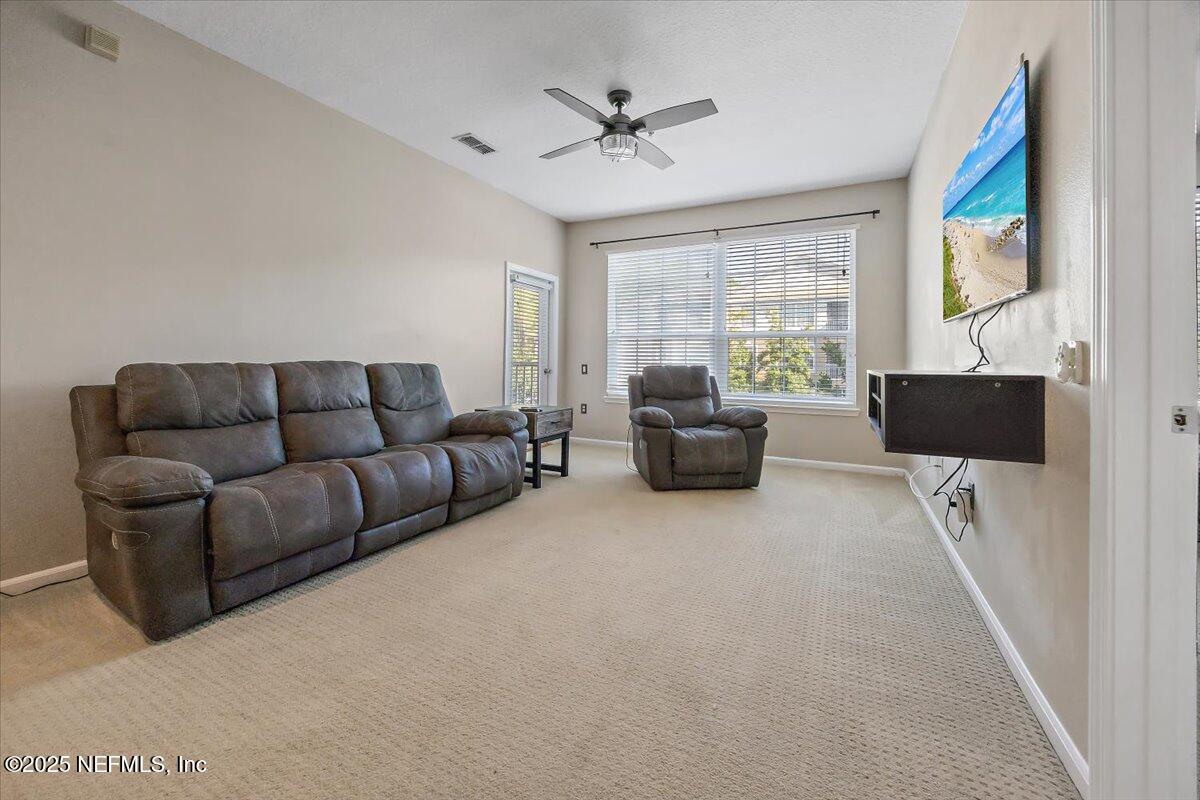 10550 Baymeadows Road, Unit 807 Jacksonville, FL 32256 - Photo 7 of 22 a living room with furniture and a large window