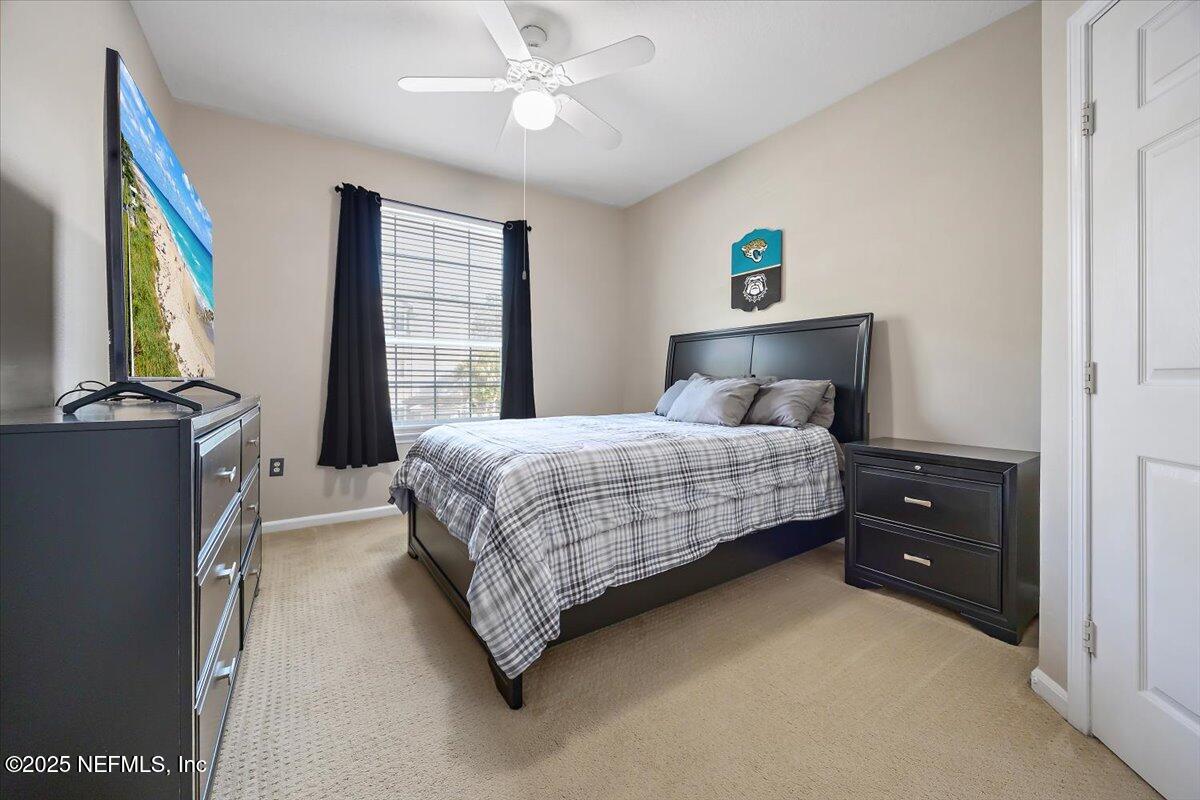 10550 Baymeadows Road, Unit 807 Jacksonville, FL 32256 - Photo 8 of 22 a bedroom with a bed and a flat tv screen on dresser