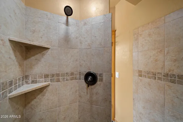 a bathroom with a shower and a sink