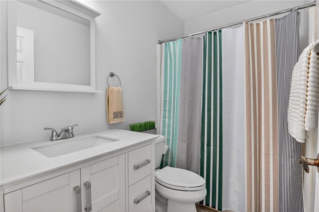 142 Roscommon Place Canonsburg, PA 15317 - Photo 25 of 31 a bathroom with a sink a toilet and mirror