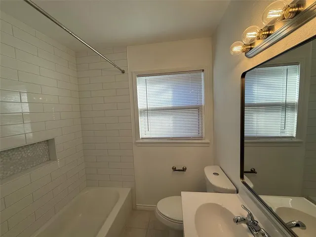 a bathroom with a sink a toilet and tub