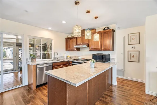 a kitchen with a stove top oven and refrigerator