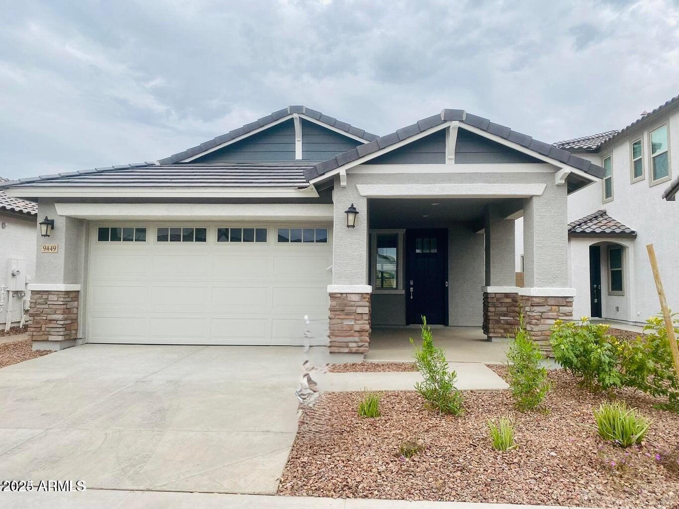 9449 West Roma Avenue Phoenix, AZ 85037 - Photo 1 of 42 a front view of a house with garden