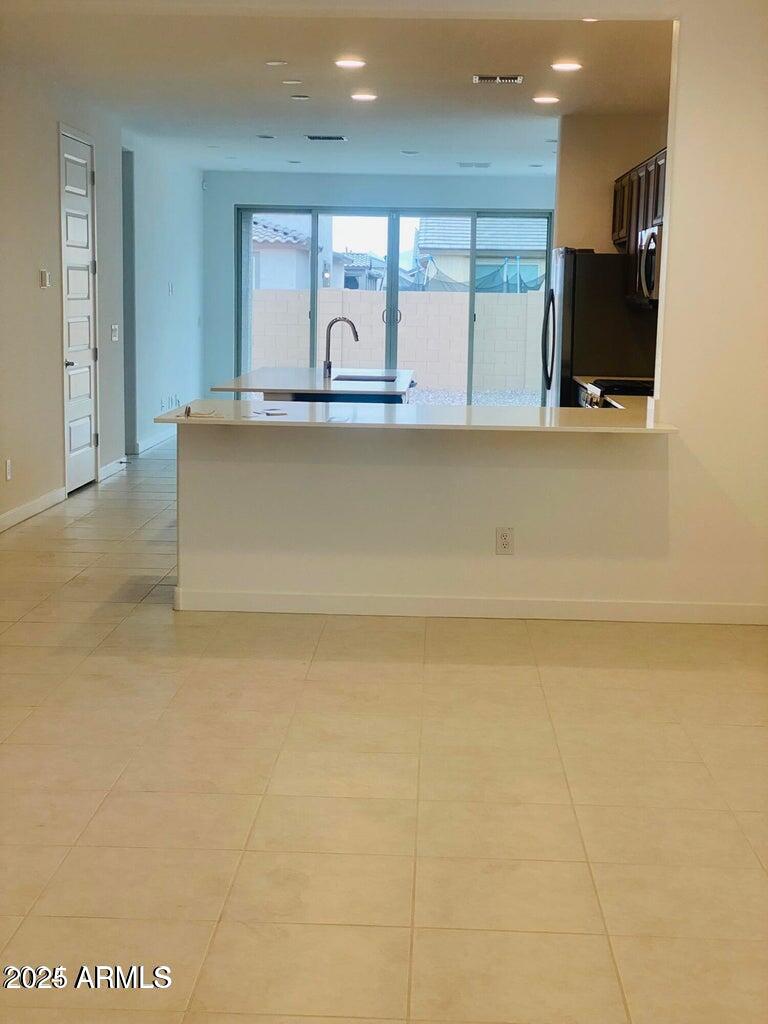 9449 West Roma Avenue Phoenix, AZ 85037 - Photo 13 of 42 a living room with a flat screen tv