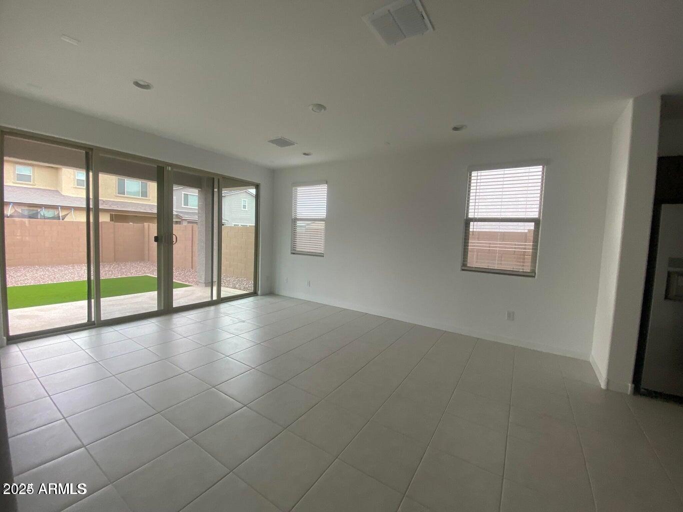 9449 West Roma Avenue Phoenix, AZ 85037 - Photo 16 of 42 wooden floor in an empty room with a window