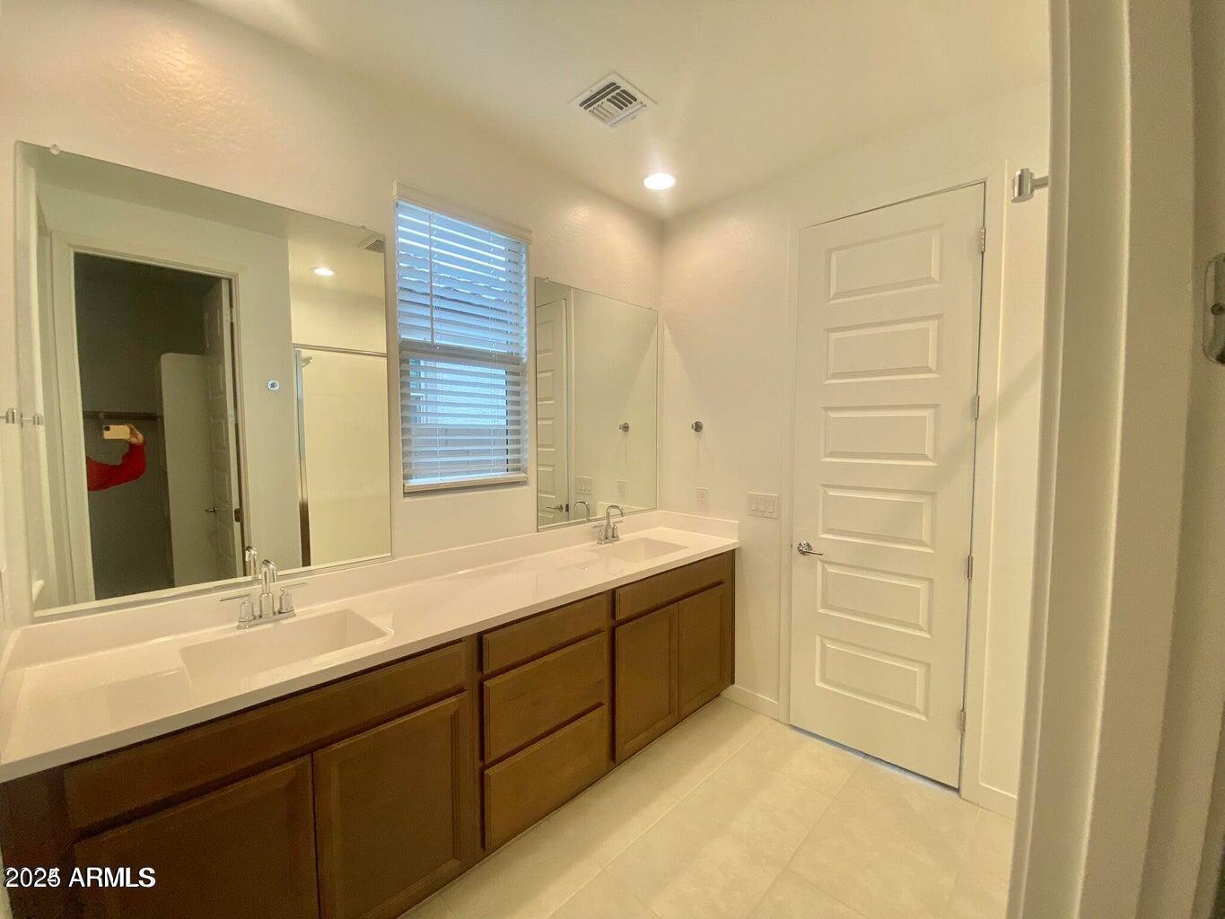 9449 West Roma Avenue Phoenix, AZ 85037 - Photo 23 of 42 a bathroom with a sink and a mirror