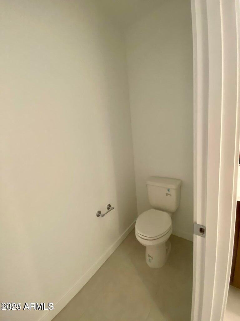 9449 West Roma Avenue Phoenix, AZ 85037 - Photo 24 of 42 a white toilet sitting next to a white wall