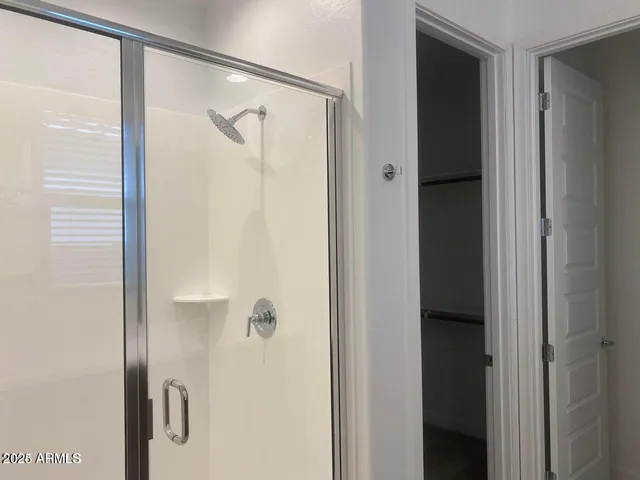 a bathroom with a glass shower door