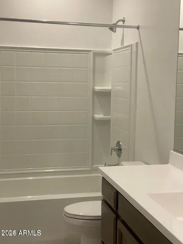 a bathroom with a tub a toilet and a shower