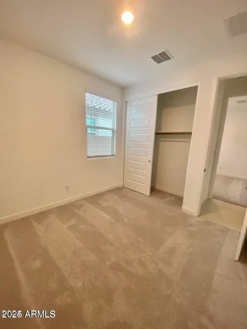 an empty room with windows and closet