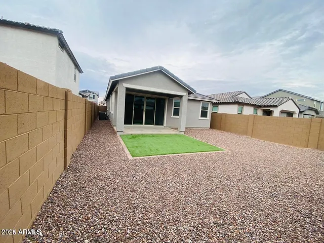 a view of house with a yard and potted plants