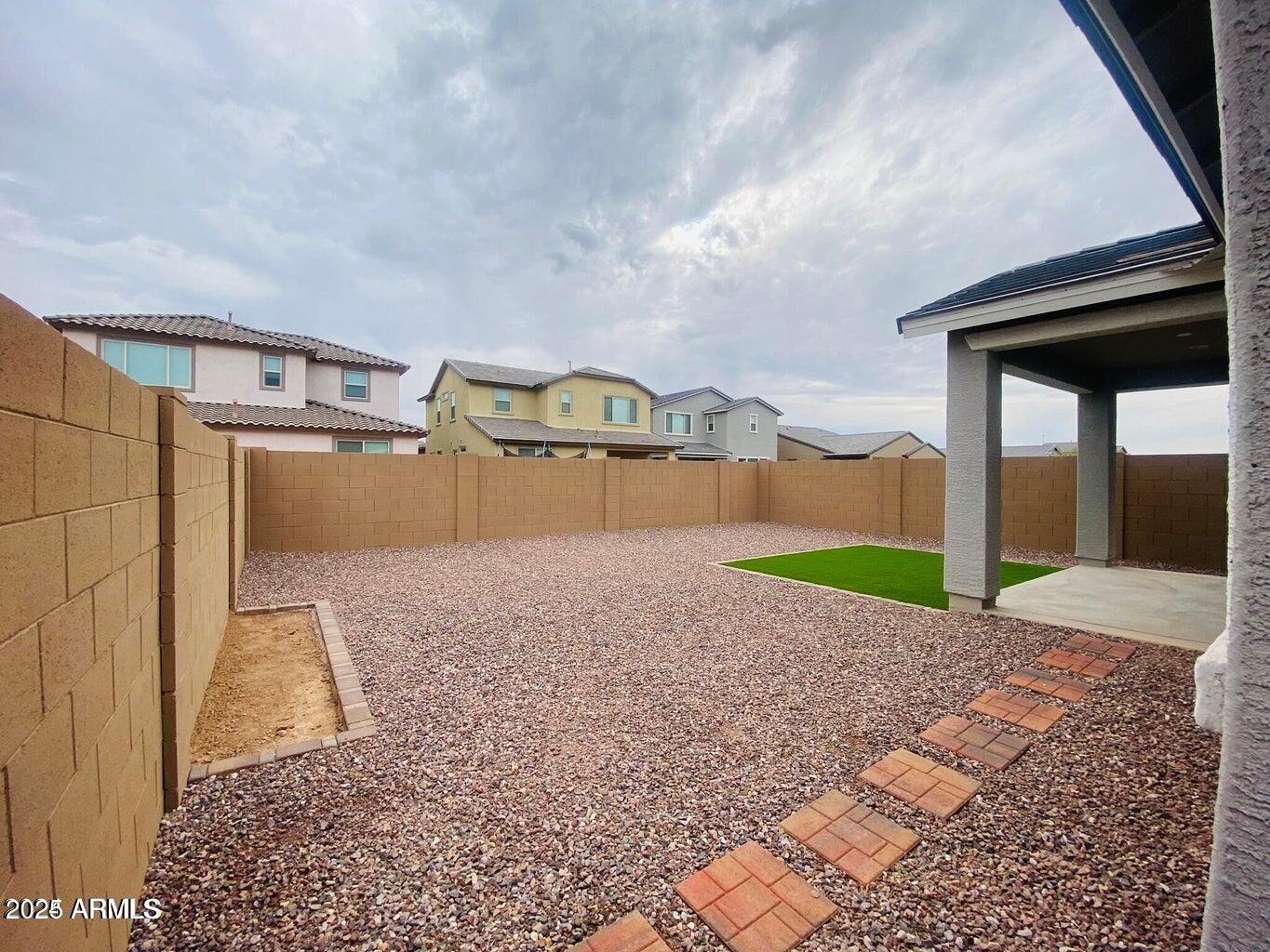 9449 West Roma Avenue Phoenix, AZ 85037 - Photo 7 of 42 a view of a house with a yard