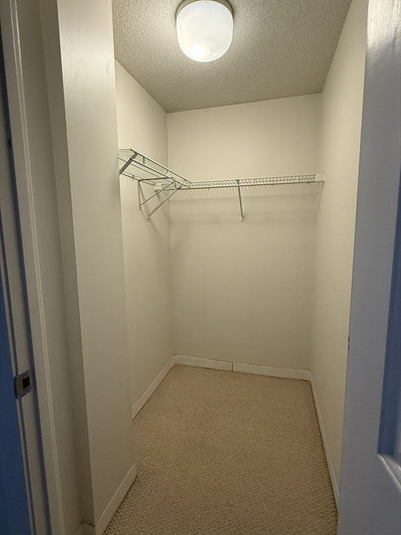 5 Bank, Unit 4A Attleboro, MA 02703 - Photo 3 of 9 a view of a room with racks on the wall