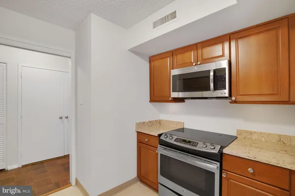 a kitchen that has a sink and a stove top oven