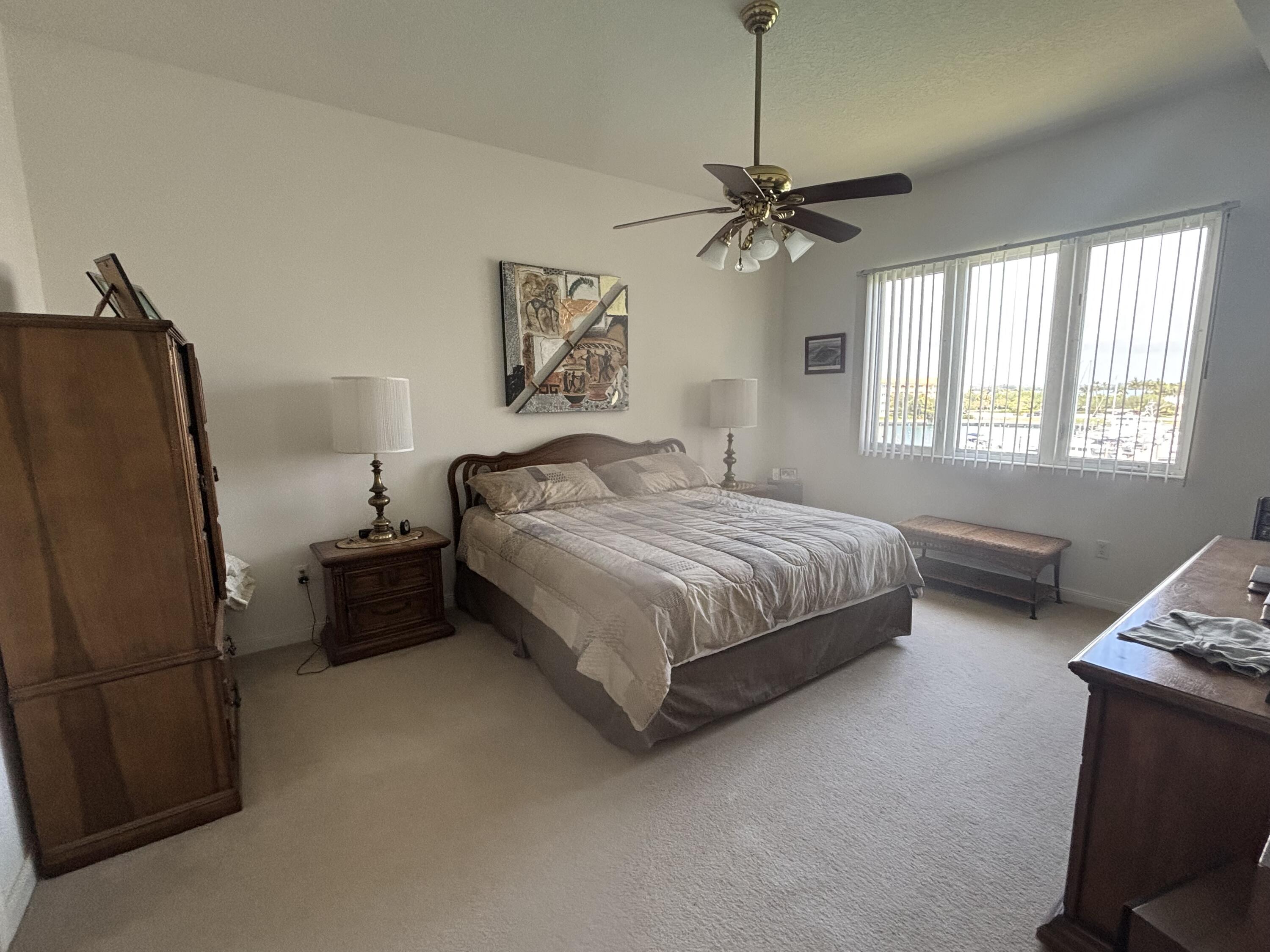 15 Harbour Isle Drive West, Unit PH 5 Fort Pierce, FL 34949 - Photo 11 of 20 a bedroom with a bed dresser and a window