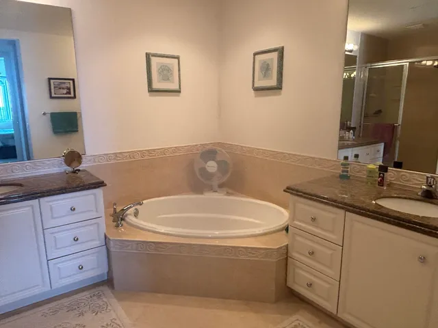a bathroom with a bathtub sink and mirror