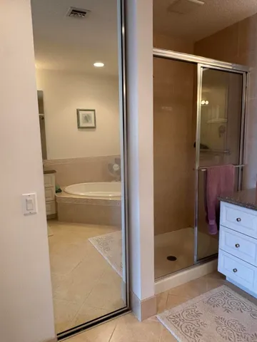 a bathroom with a shower and mirror