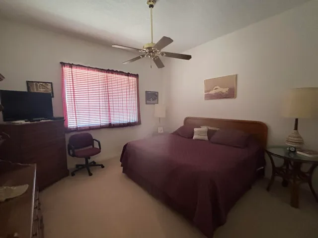 a bedroom with a bed window and a desk