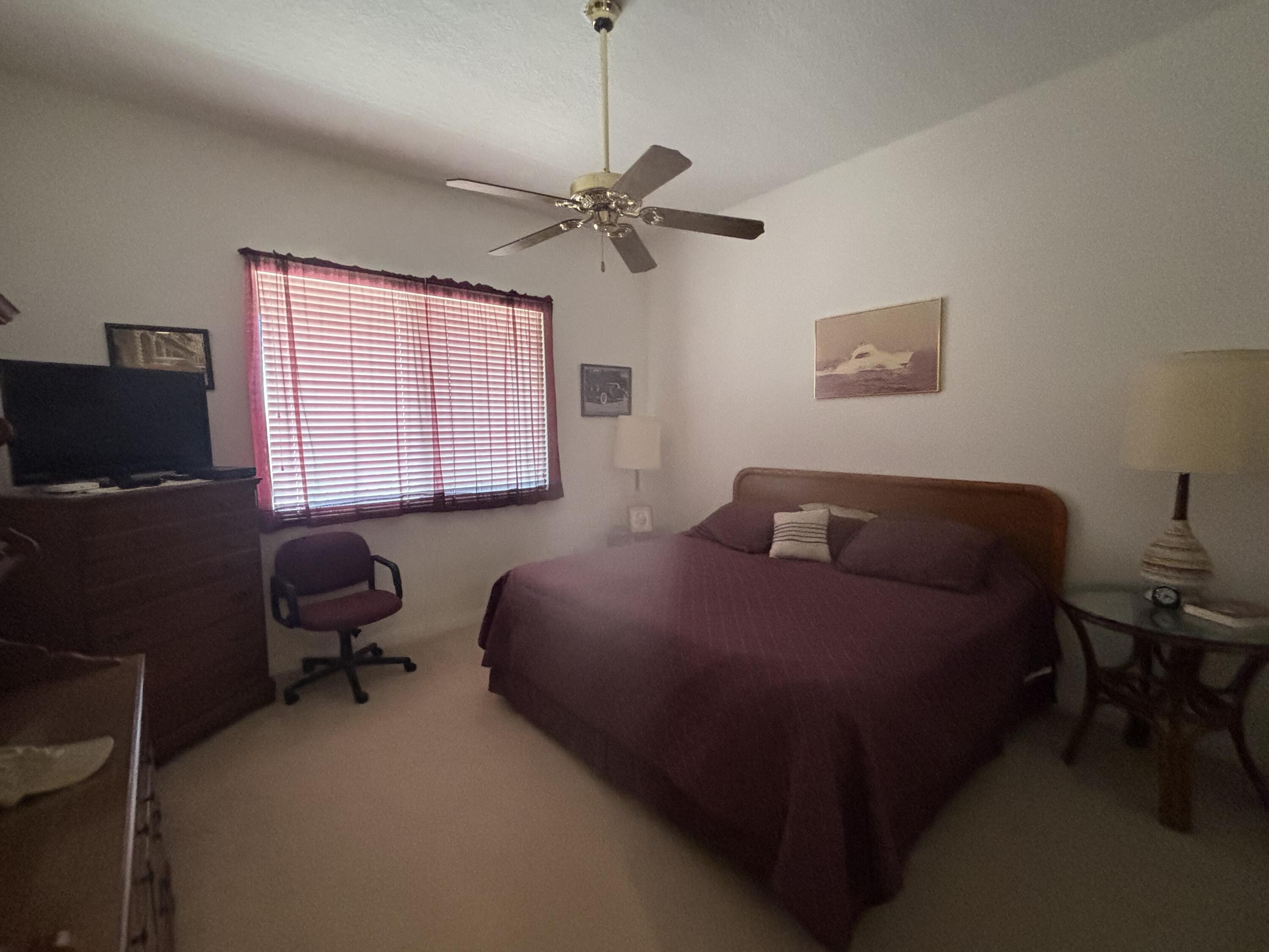 15 Harbour Isle Drive West, Unit PH 5 Fort Pierce, FL 34949 - Photo 15 of 20 a bedroom with a bed window and a desk