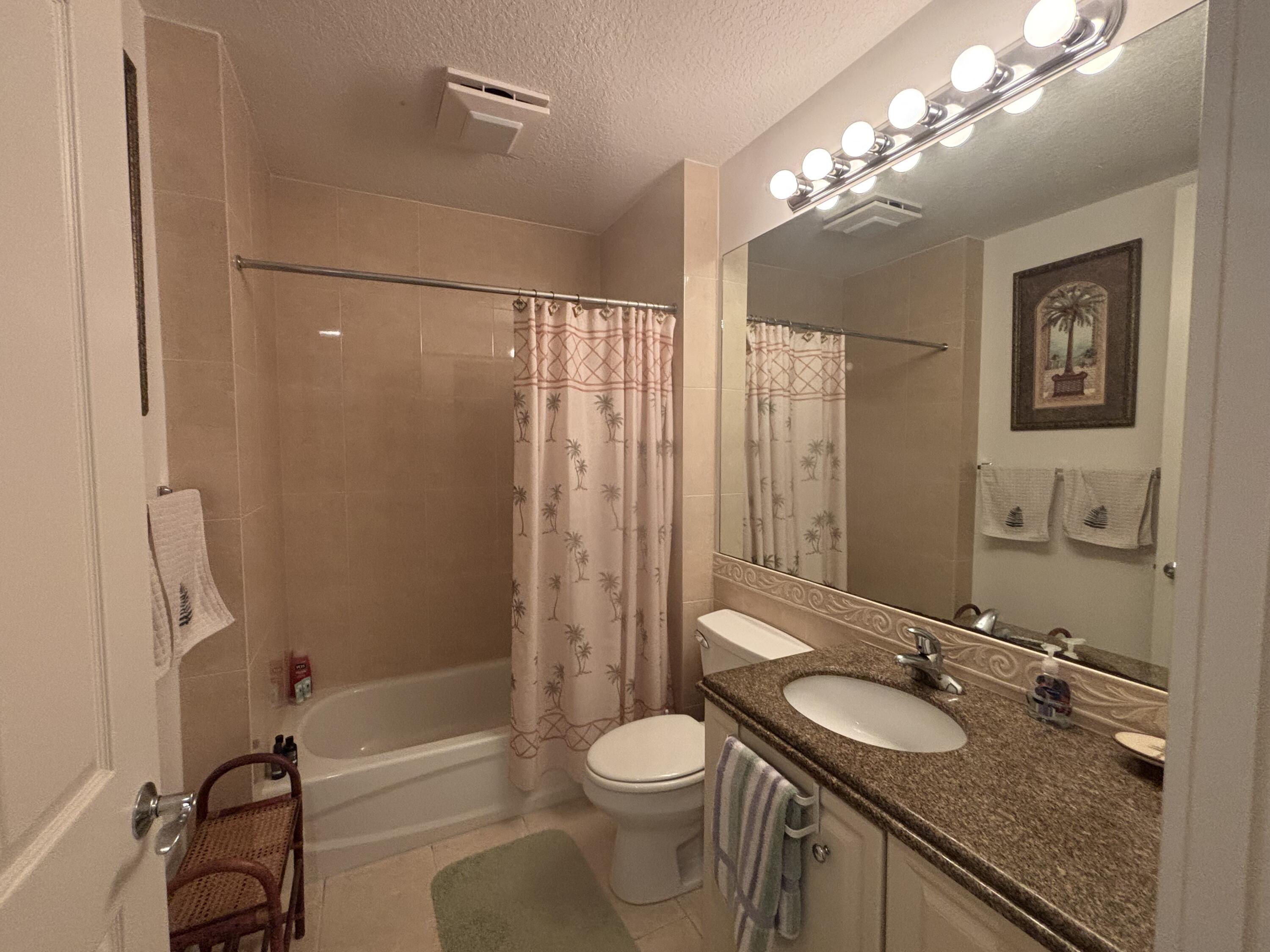 15 Harbour Isle Drive West, Unit PH 5 Fort Pierce, FL 34949 - Photo 17 of 20 a bathroom with a granite countertop sink toilet and shower