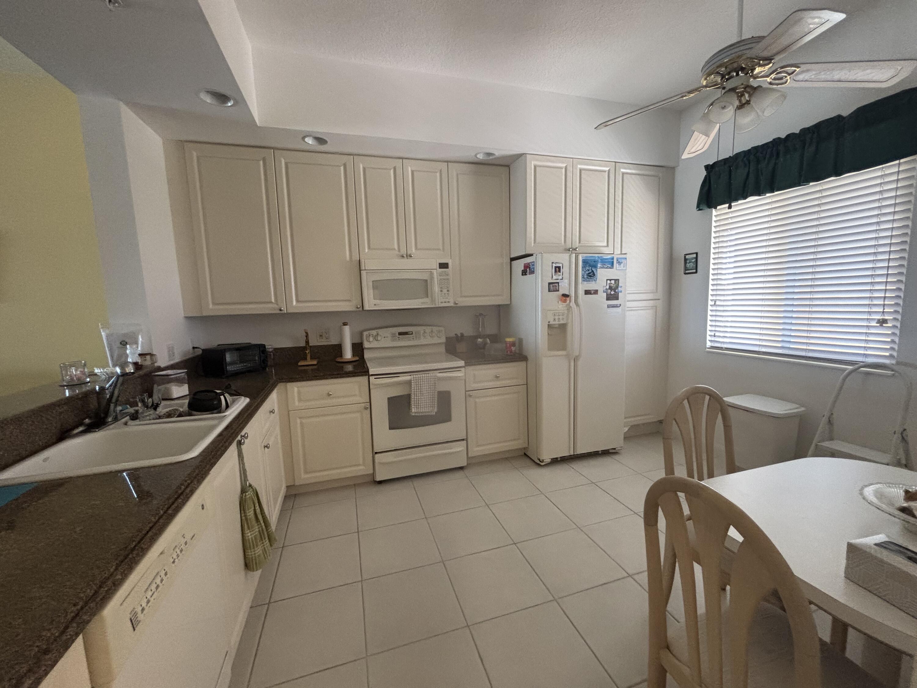 15 Harbour Isle Drive West, Unit PH 5 Fort Pierce, FL 34949 - Photo 3 of 20 a kitchen with a sink appliances cabinets and furniture
