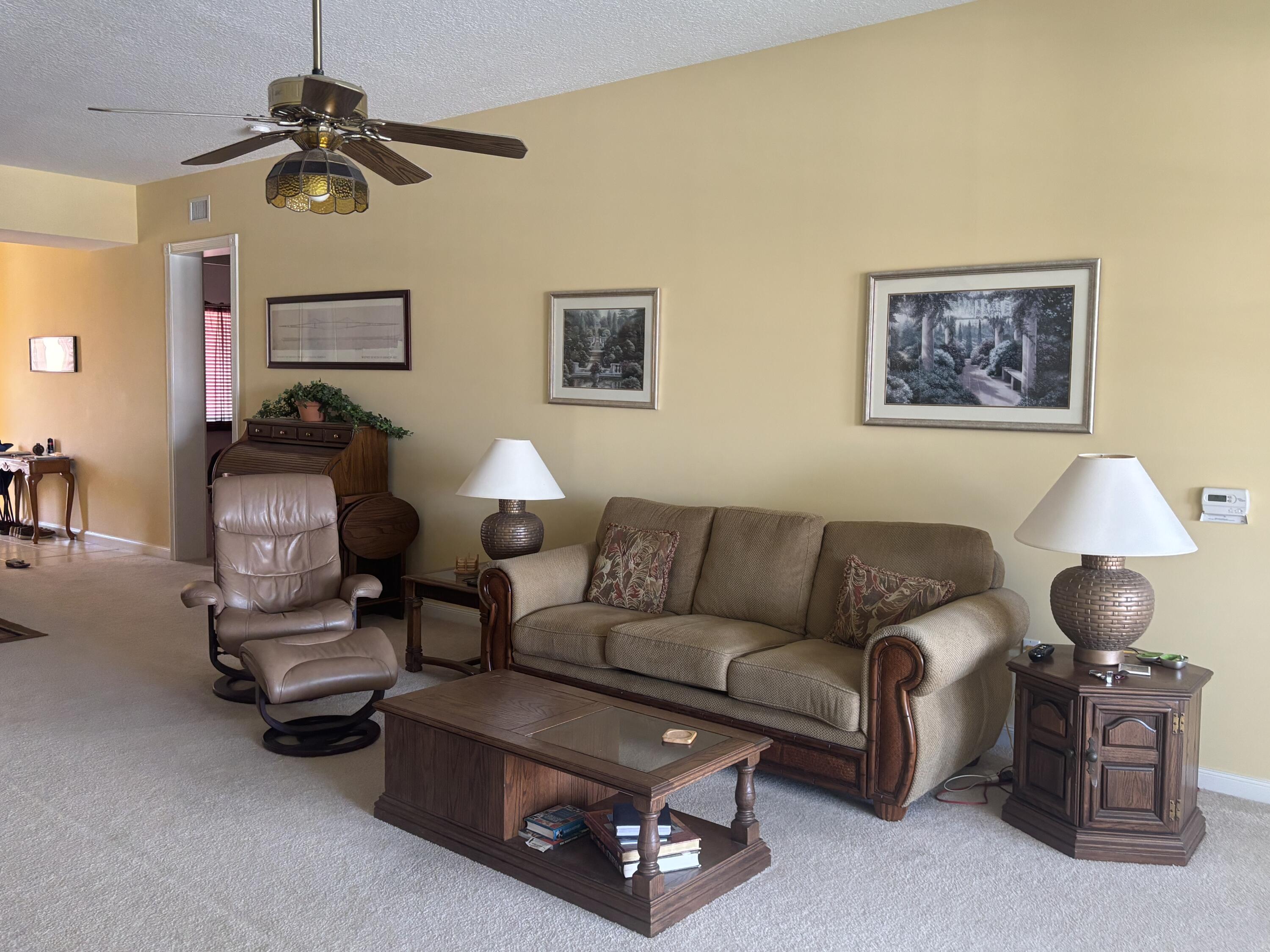 15 Harbour Isle Drive West, Unit PH 5 Fort Pierce, FL 34949 - Photo 7 of 20 a living room with furniture and a lamp