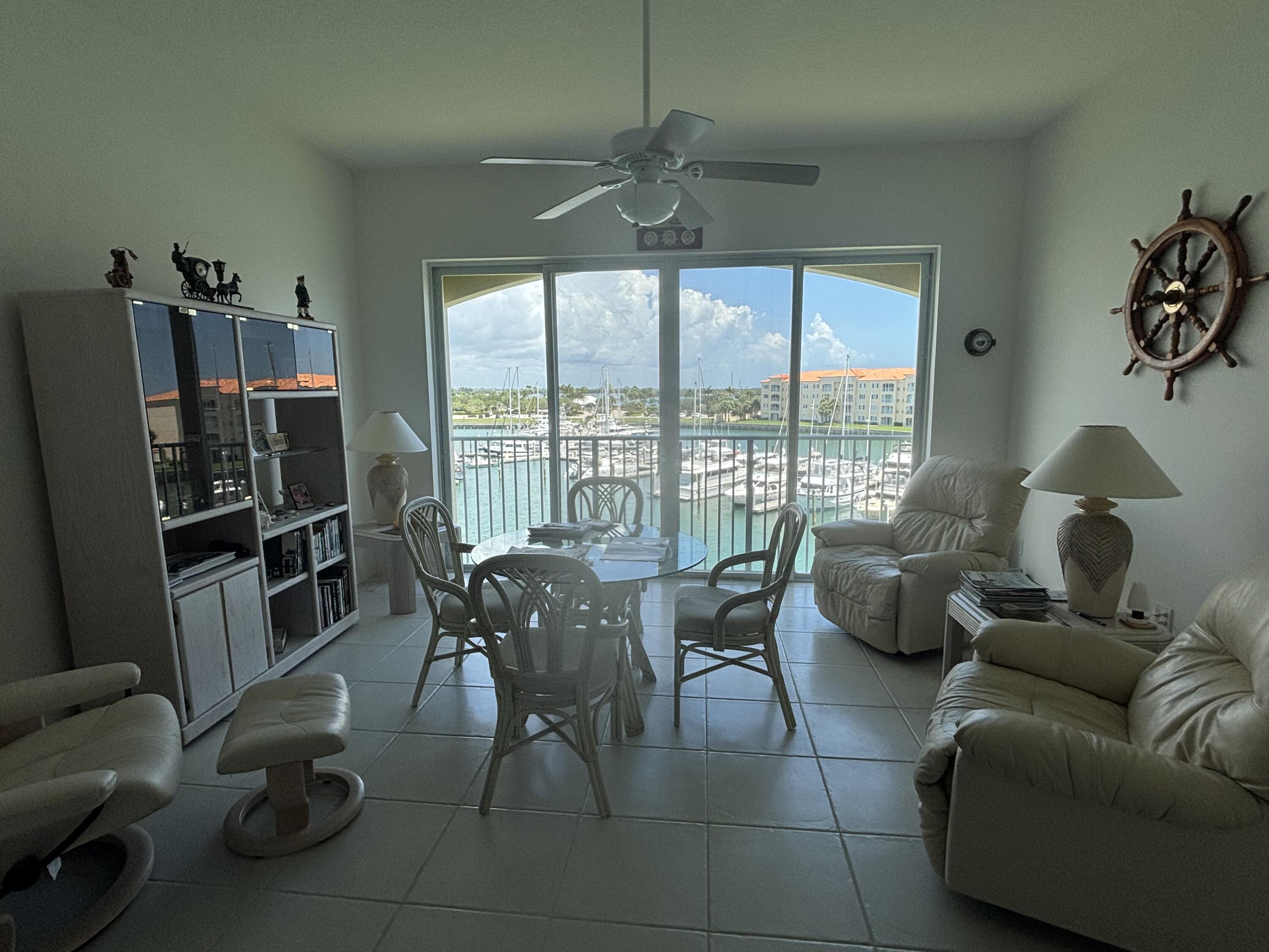 15 Harbour Isle Drive West, Unit PH 5 Fort Pierce, FL 34949 - Photo 9 of 20 a living room with furniture and a floor to ceiling window
