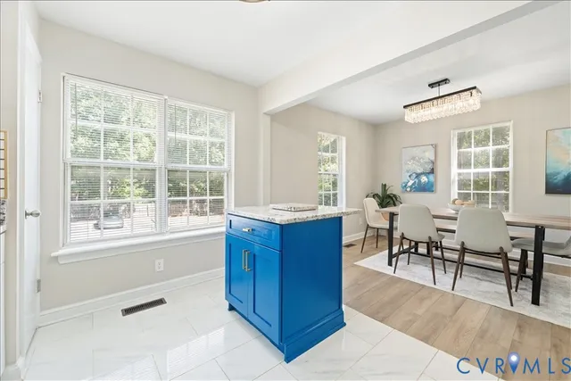 a living room with furniture a dining table and a large window
