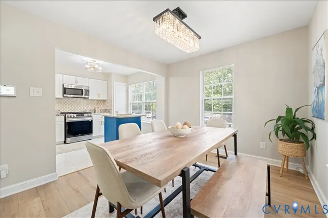 a view of a dining room with furniture and a fireplace