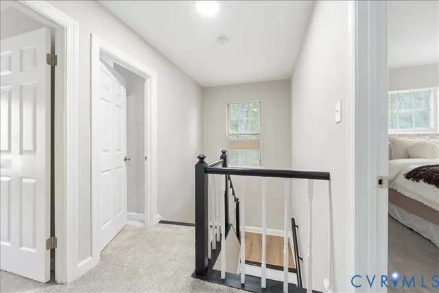 a view of a bedroom with wooden floor and windows