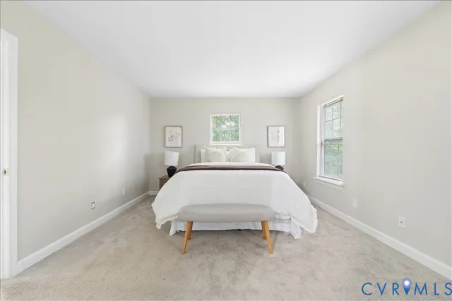 a bed sitting in a bedroom next to a window