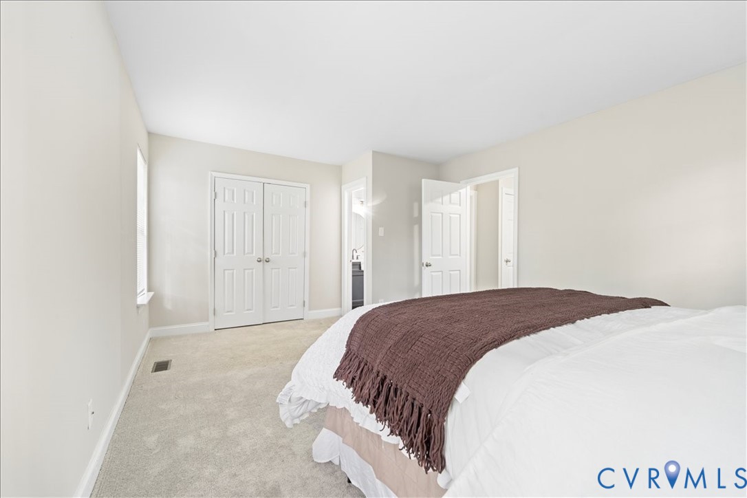 11601 Timberly Waye Henrico, VA 23238 - Photo 21 of 39 a spacious bedroom with a bed and a cabinets