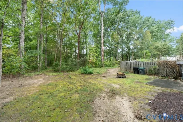 a backyard of a house with plants and trees
