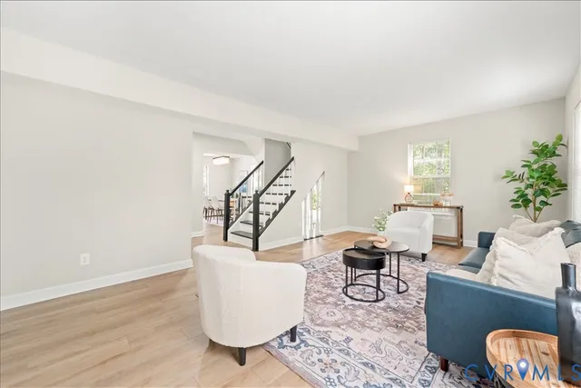 a living room with furniture and a potted plant