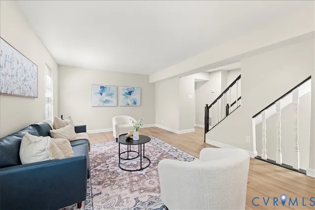 a living room with furniture and a painting on the wall