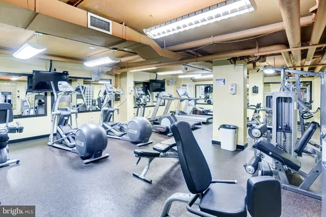 a room with gym equipment and a large window