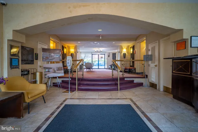 a living room with furniture a chandelier and a large window