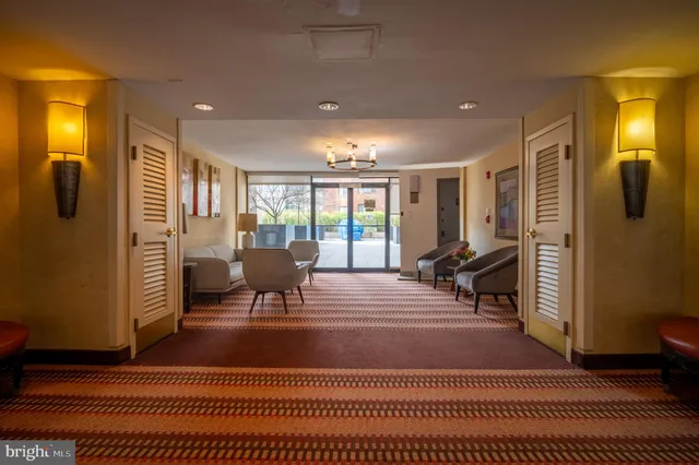a hotel room with a bed and large windows
