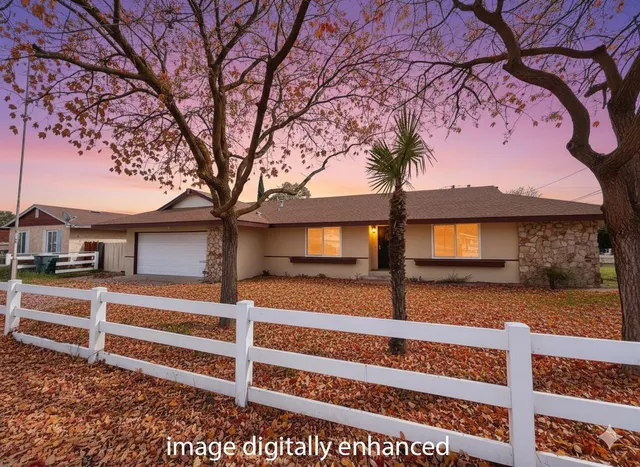 a view of a house with a large tree