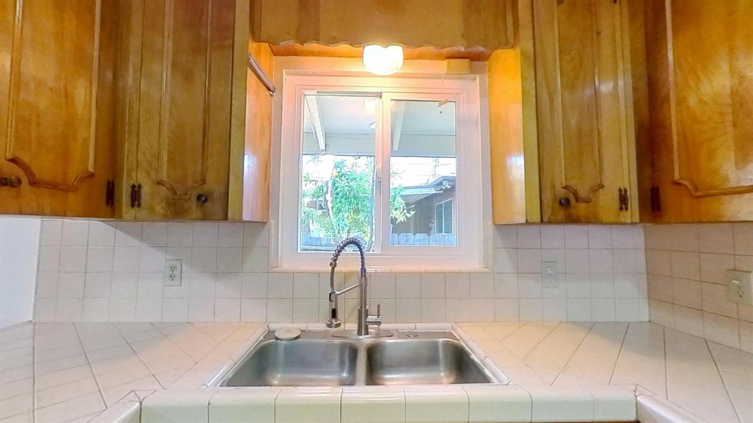 1164 Marion Street Manteca, CA 95337 - Photo 3 of 11 a bathroom with a sink and a large mirror