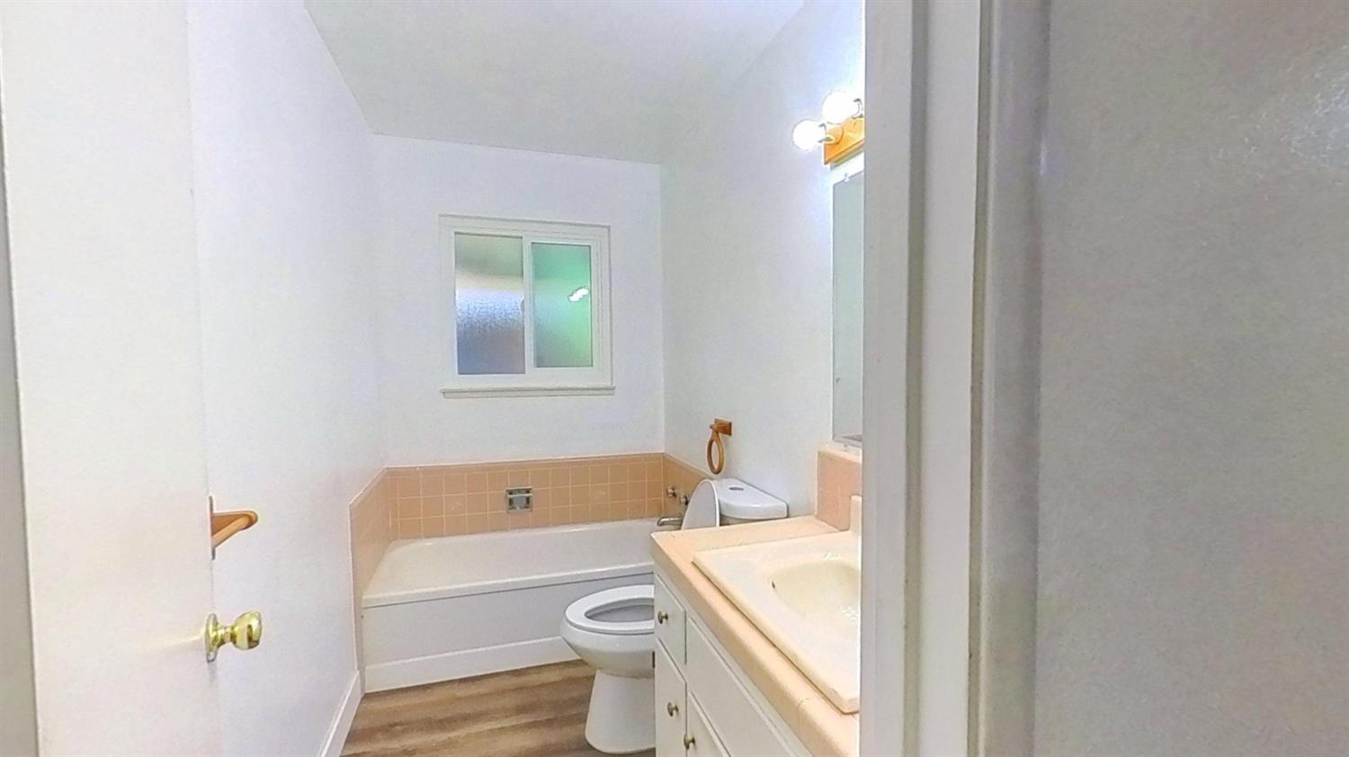 1164 Marion Street Manteca, CA 95337 - Photo 4 of 11 a bathroom with a sink toilet vanity and bathtub