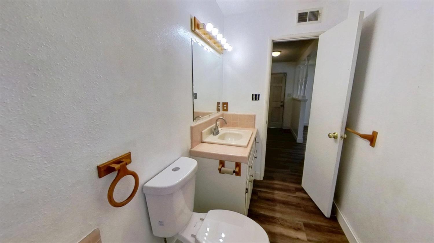 1164 Marion Street Manteca, CA 95337 - Photo 5 of 11 a bathroom with a granite countertop shower and a toilet