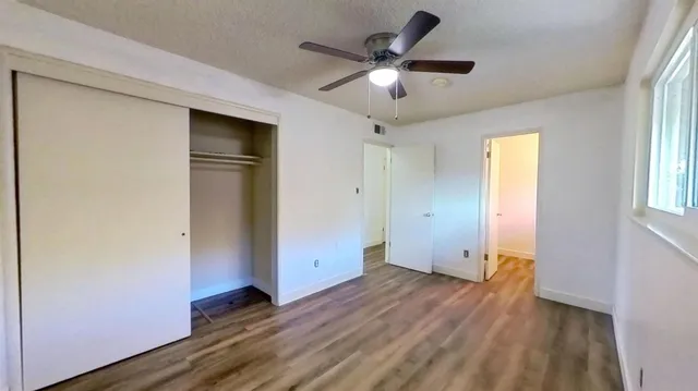 wooden floor in an empty room with a window