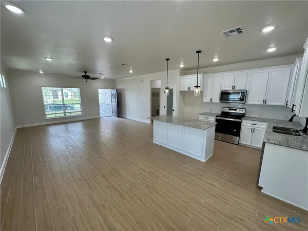 a large kitchen with stainless steel appliances