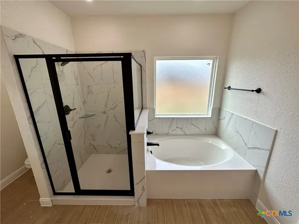a bathroom with a bathtub and a shower