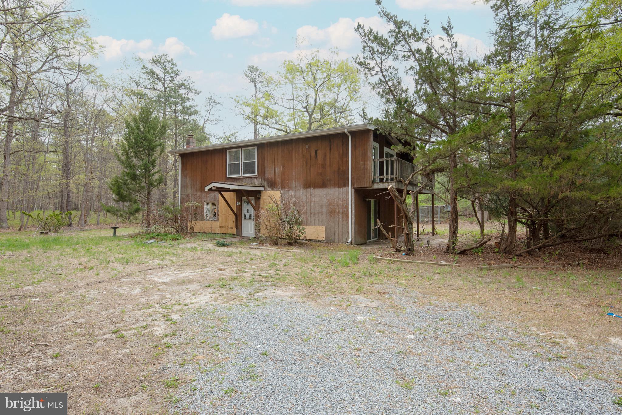 a backyard of a house with barbeque oven and outdoor seating