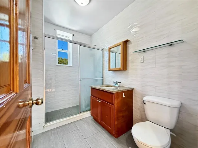 a bathroom with a toilet a sink and shower