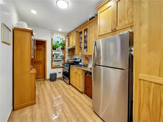a kitchen with stainless steel appliances a refrigerator sink and cabinets