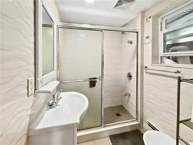 a picture of a bathroom with a shower