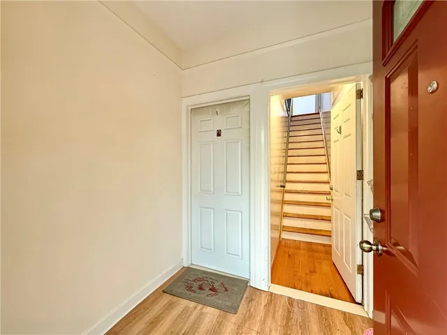 a view of a room with wooden floor and cabinet